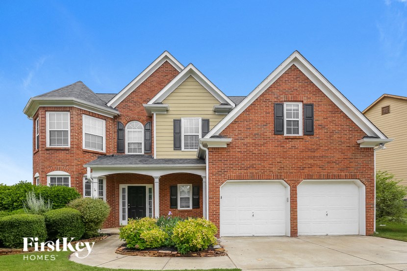 a brick house with two garage doors