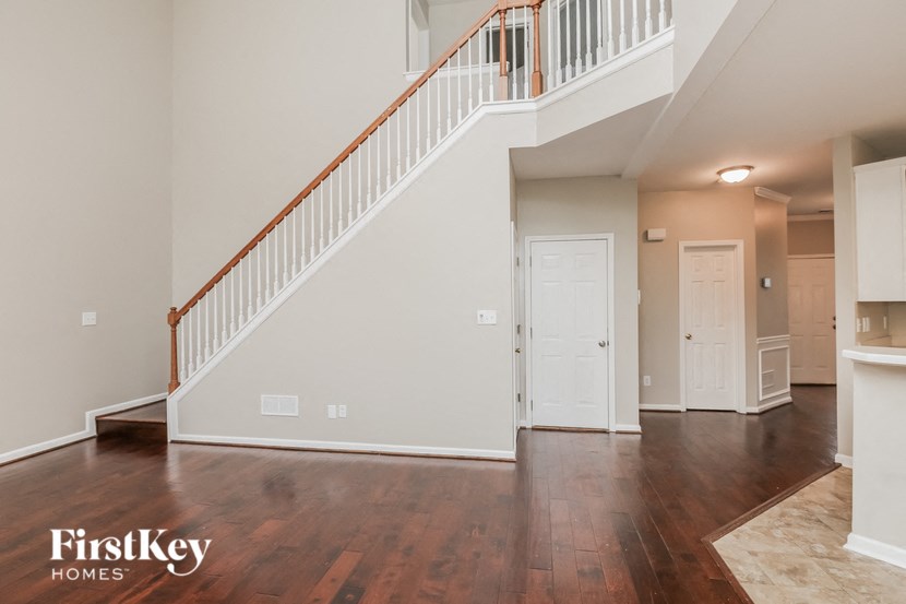 an open living room with a staircase and a white door