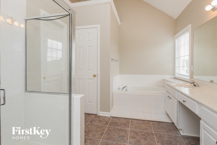 a bathroom with a shower and a sink and a mirror