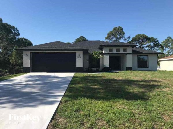 a house with a driveway and a black garage door