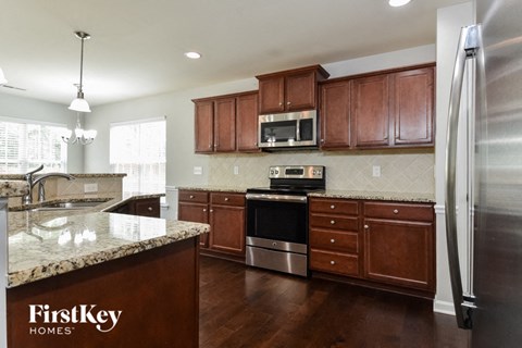 a kitchen with wooden cabinets and stainless steel appliances