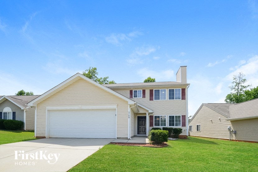 A house with a garage is for sale.