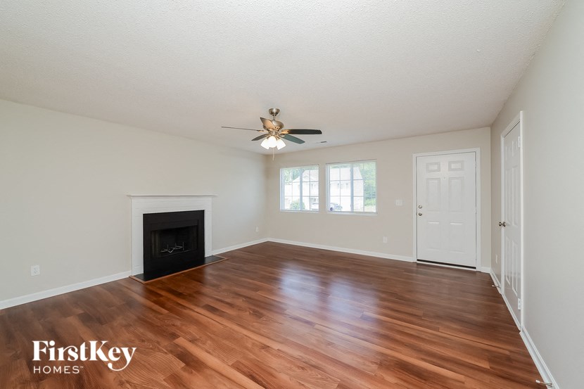 A room with a fireplace and wooden floors.