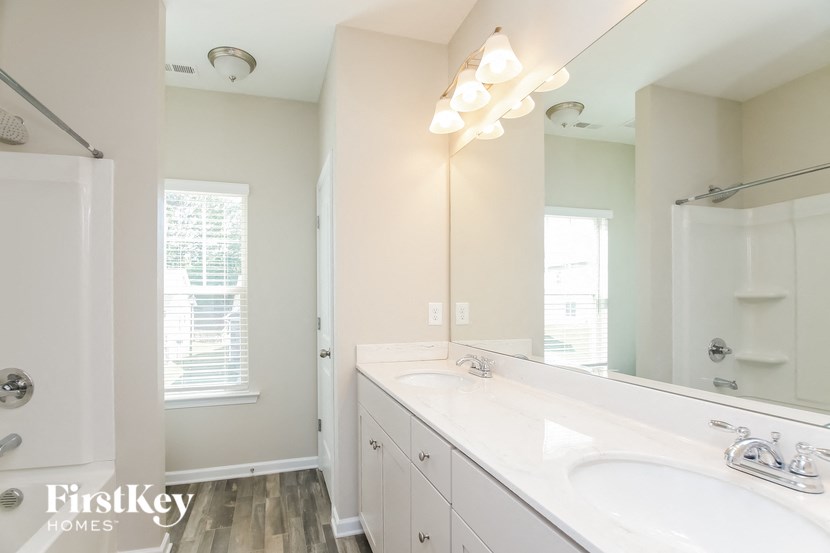 a bathroom with two sinks and a large mirror
