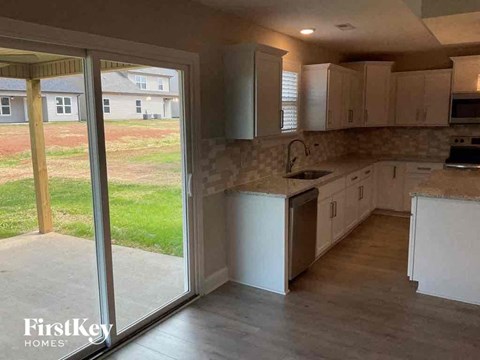 a kitchen with a sliding glass door to the yard
