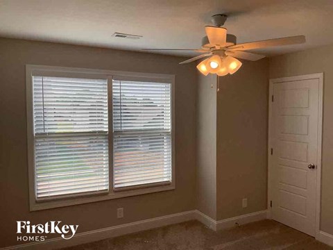a living room with a ceiling fan and a window