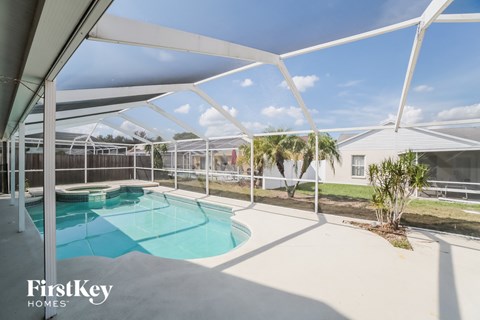 A swimming pool under a white canopy.