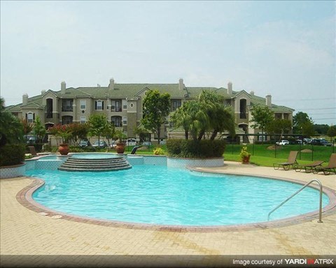 a swimming pool with an apartment building in the background