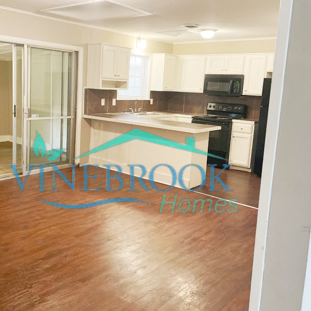 a view of a kitchen from the living room