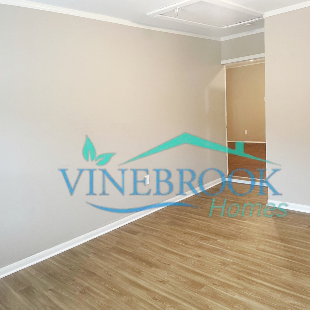 a living room with a white wall and a logo on it