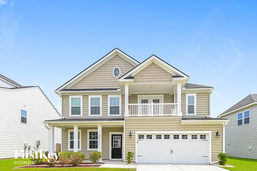 A two-story house with a garage is showcased in the image.
