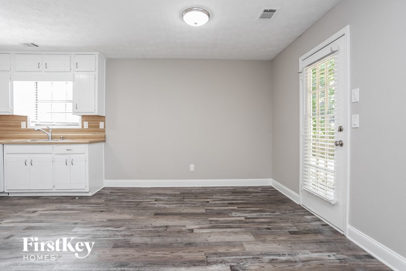 the kitchen and living room of a house with wood floors