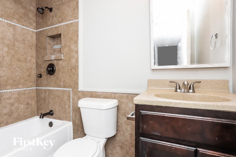 a bathroom with a toilet and a sink and a mirror