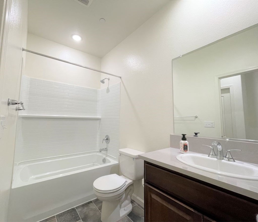 a bathroom with a shower toilet and sink