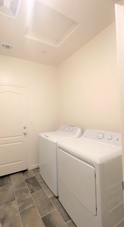 two white washers and dryers in a white laundry room