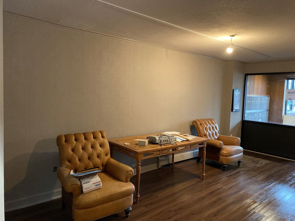 a living room with two chairs and a table