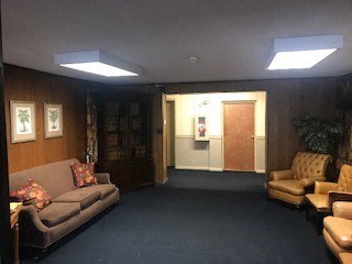 a living room with couches and chairs and a door