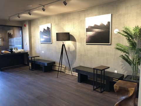 a living room with a lamp and pictures on the wall