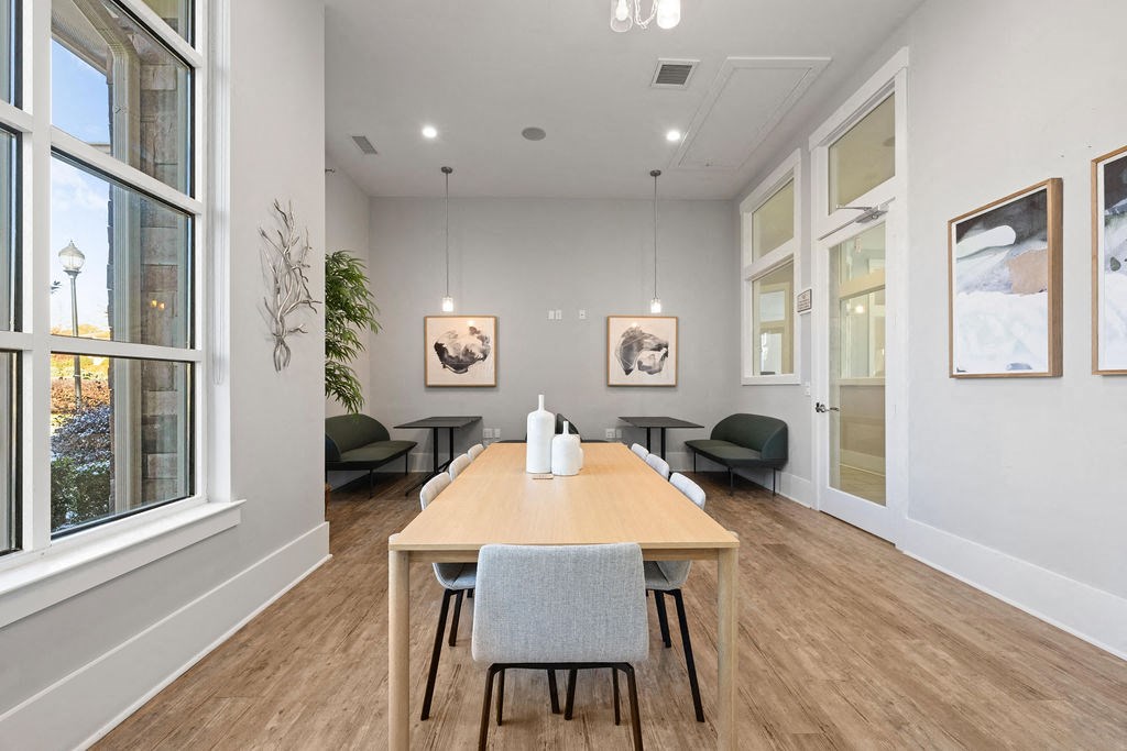 A dining room with a wooden table and chairs.