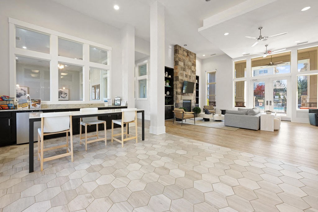 A spacious kitchen and living room with a dining table and chairs.
