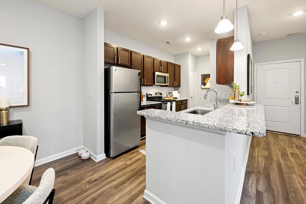 A kitchen with a white island and a refrigerator.