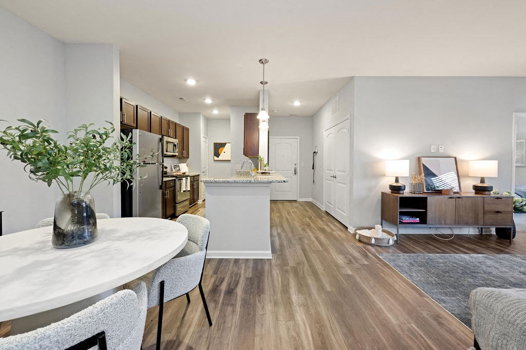 A modern kitchen with a dining table and chairs.