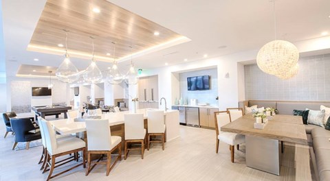 A modern dining room with a large table and chairs.