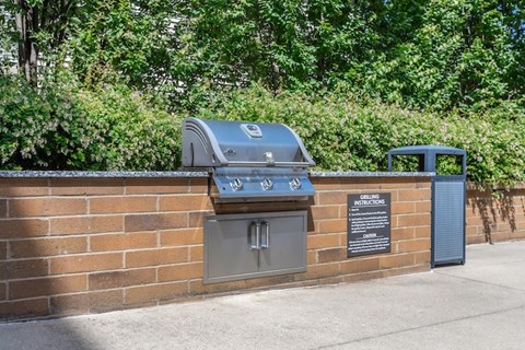 A brick wall with a grill and a sign that says "No Grilling".