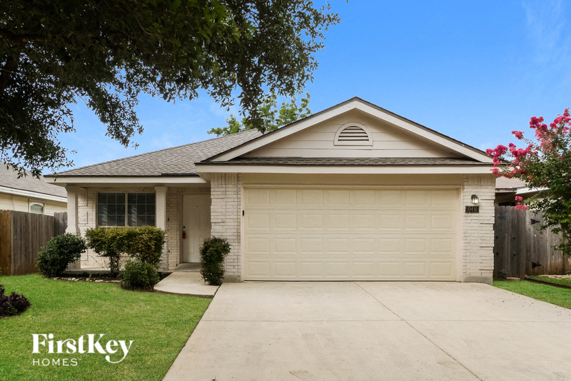 a white house with a driveway and a garage door