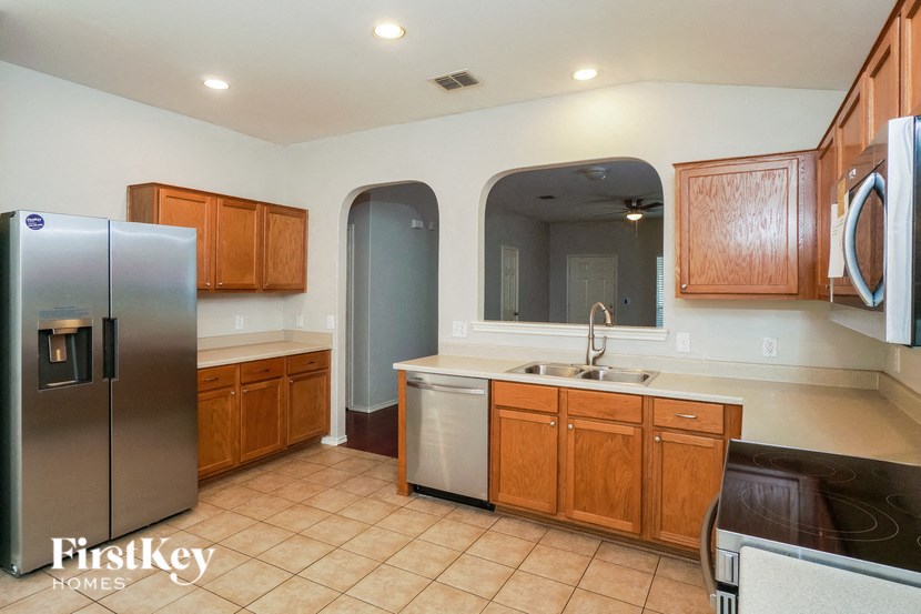 a kitchen with stainless steel appliances and wooden cabinets