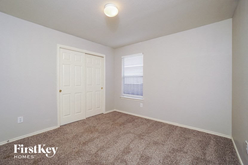 an empty room with carpet and a white door