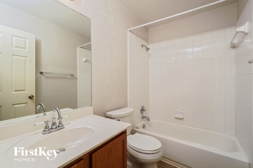 a bathroom with a sink toilet and a tub