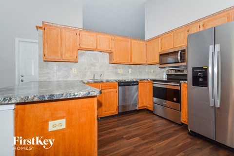 a kitchen with wooden cabinets and stainless steel appliances