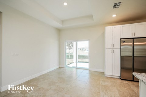 a large kitchen with stainless steel appliances and white cabinets
