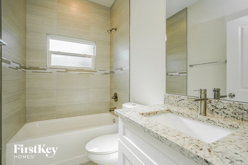 a bathroom with a sink and a toilet and a tub