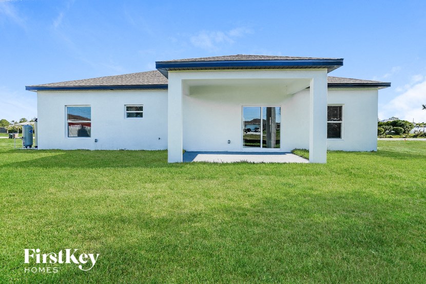 a white house with a lawn in front of it