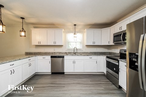 A kitchen with white cabinets and stainless steel appliances.