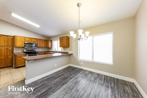 A kitchen with wooden cabinets and a grey countertop.