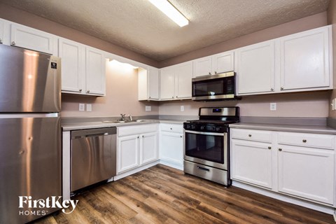 a kitchen with stainless steel appliances and white cabinets