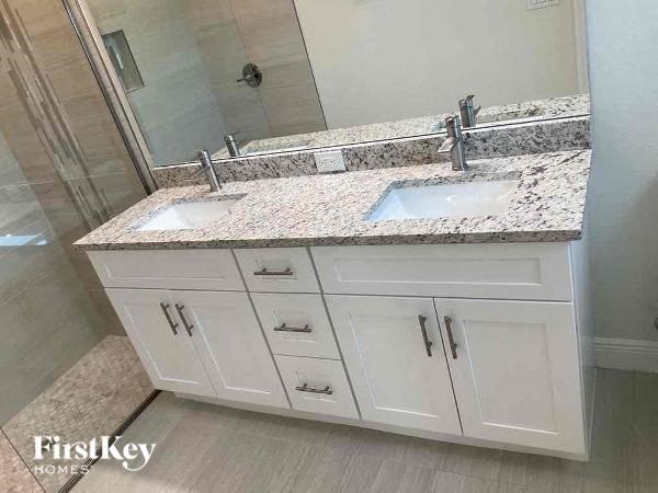 a bathroom with two sinks and a mirror