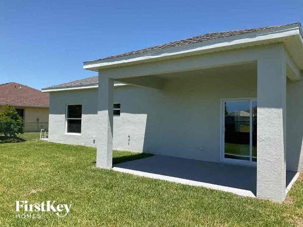 a white house with a lawn in front of it