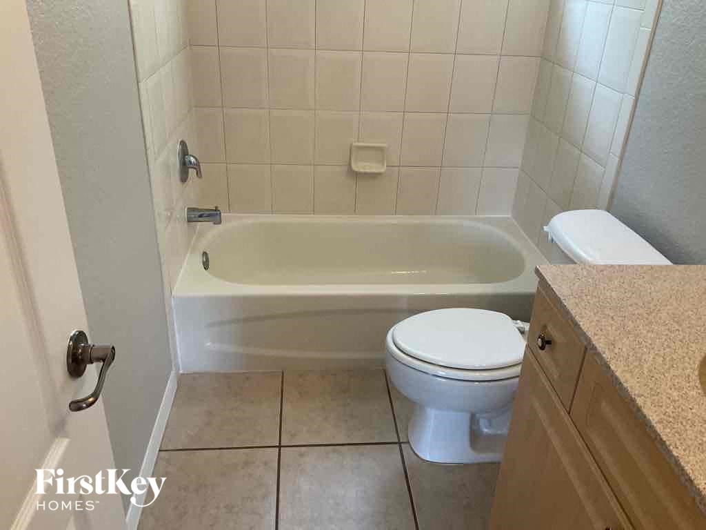 a bathroom with a toilet and a bath tub