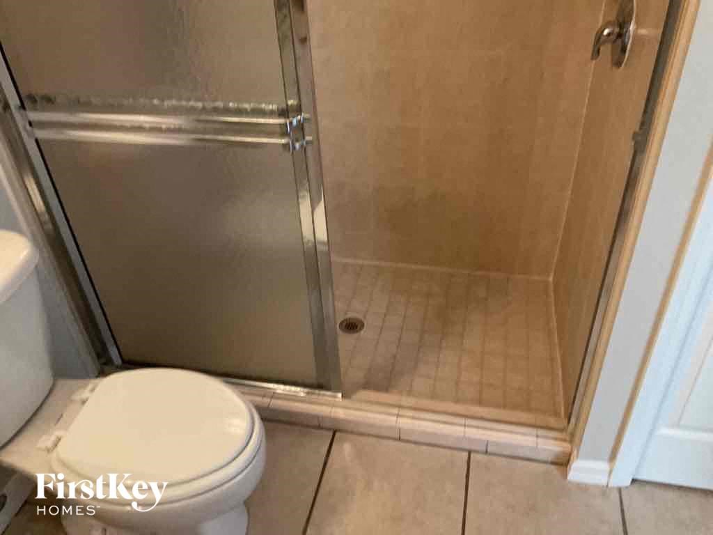 a small bathroom with a toilet and a shower