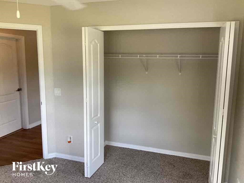 an empty closet in a room with a door open
