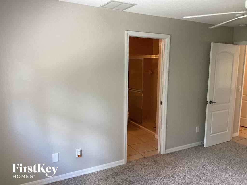 a bedroom with a closet and a door to a bathroom