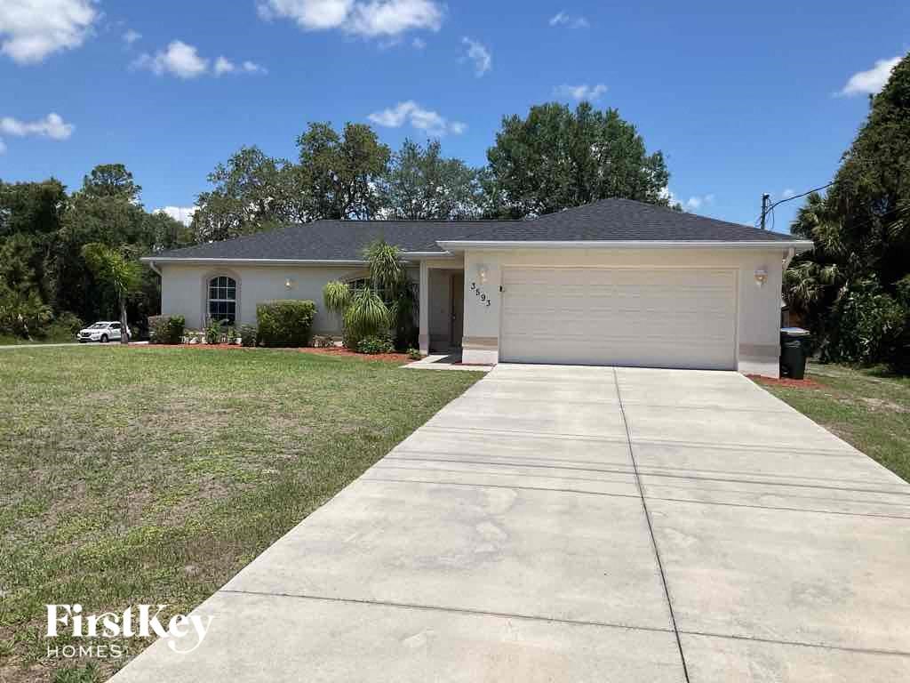 a home with a driveway and a garage door