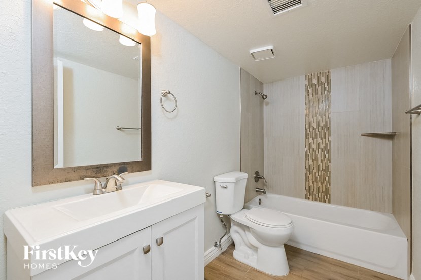 a bathroom with a sink toilet and a bath tub