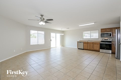 A spacious kitchen with a refrigerator, microwave, and oven.