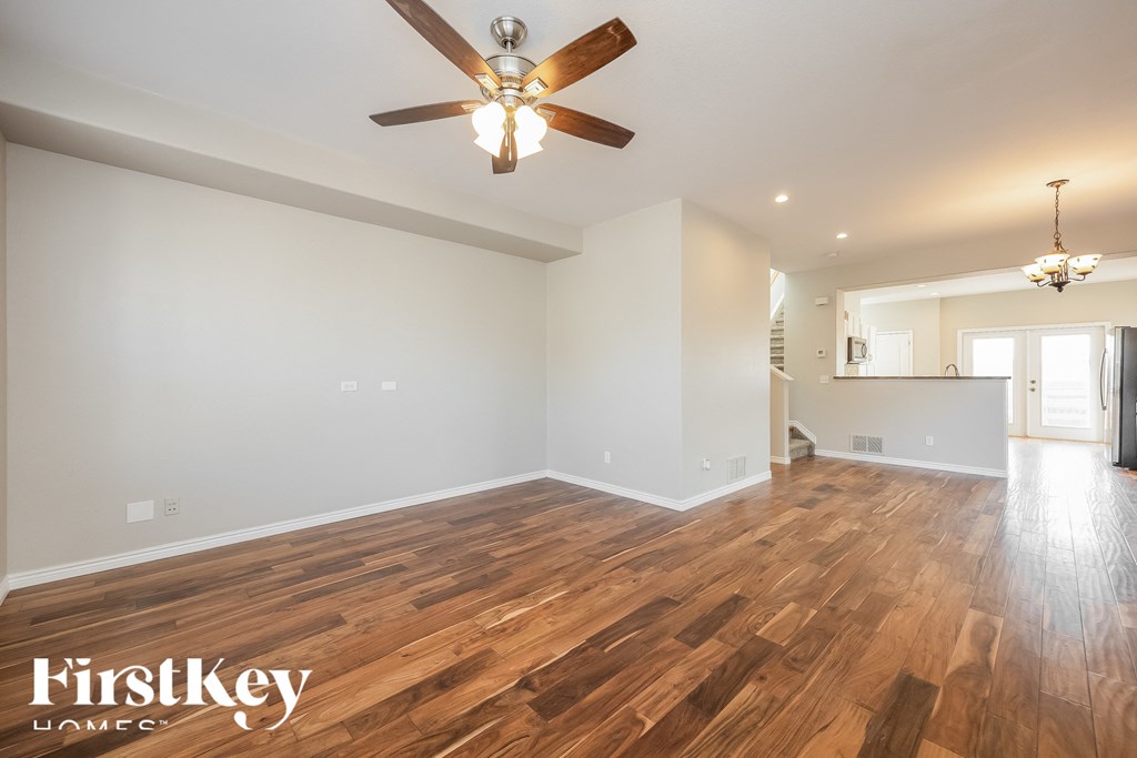 A room with wooden floors and a ceiling fan.