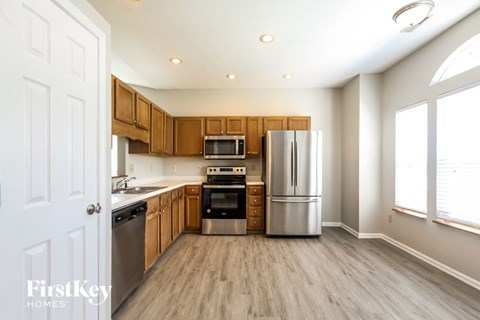 A kitchen with wooden cabinets and stainless steel appliances.